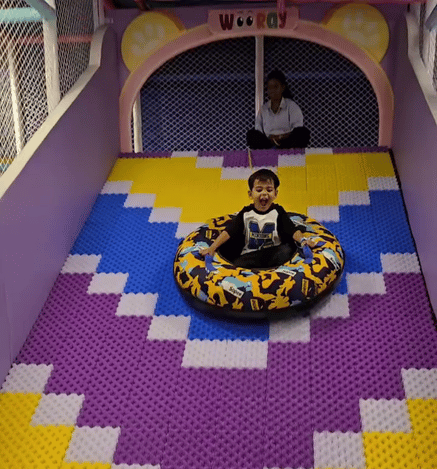 A child enjoying the bumper car ride at Wooray's indoor play area