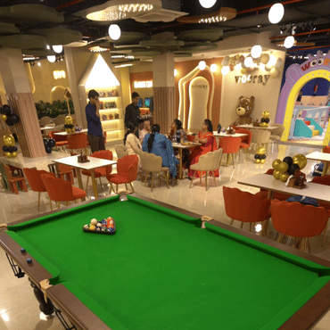 Colourful indoor party and dining area with families enjoying their time at Wooray Patna.