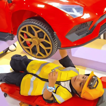 Child dressed as a mechanic enjoying a pretend car repair activity at Wooray Patna.